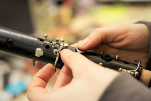 Someone repairing a wood instrument