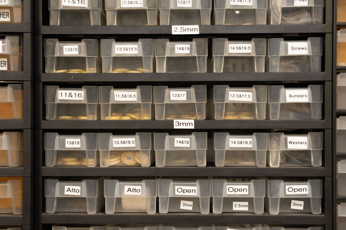 Different drawers with music repair related items