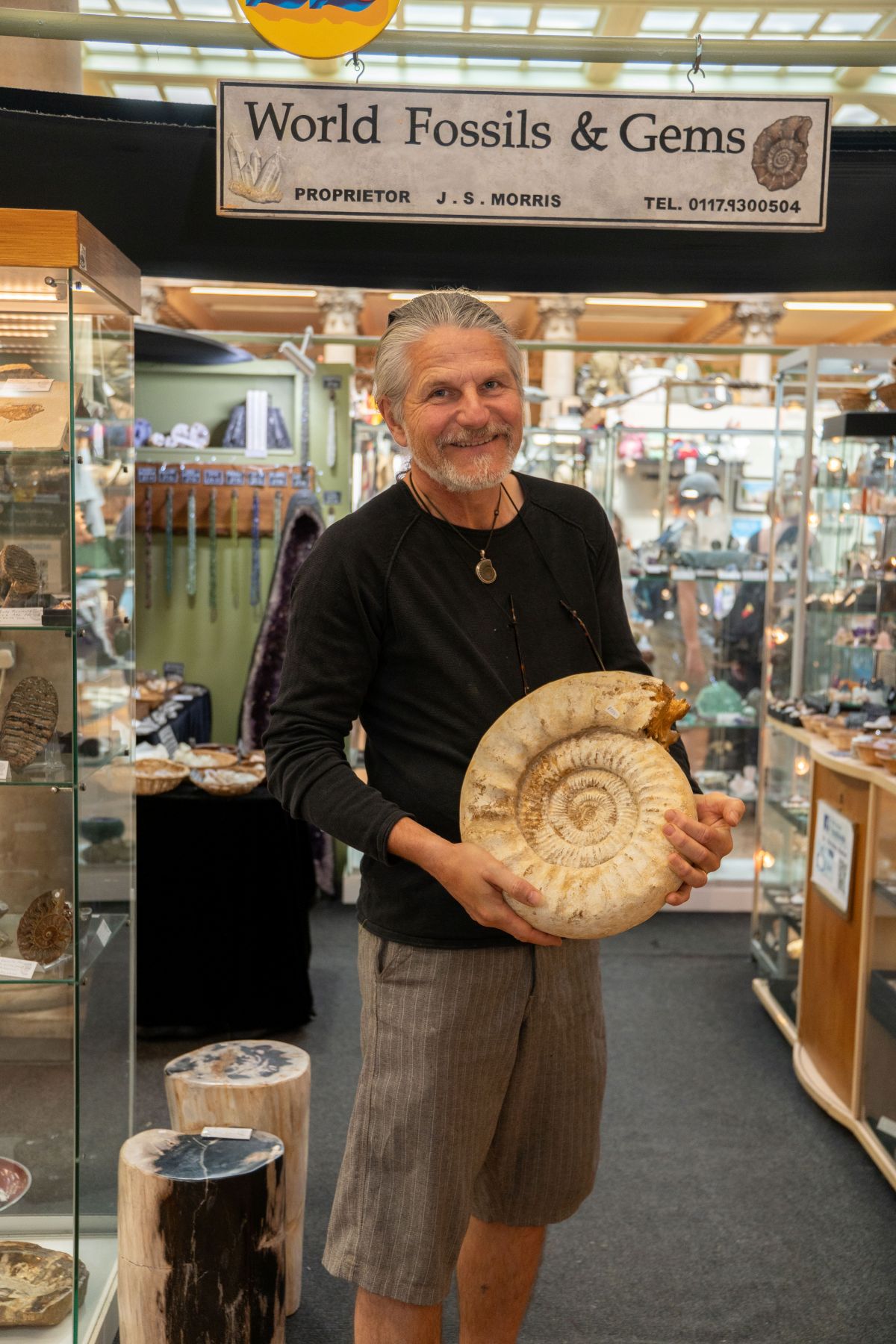 A man holding up a large fossil