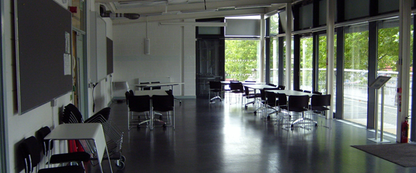 a spacious room with tables and chairs 