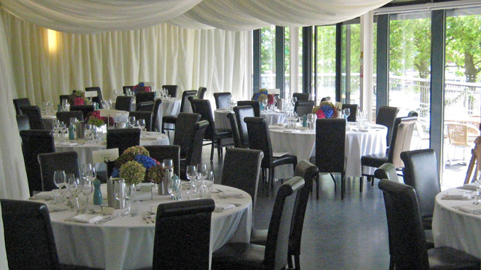 A room set up cabaret-style for a reception