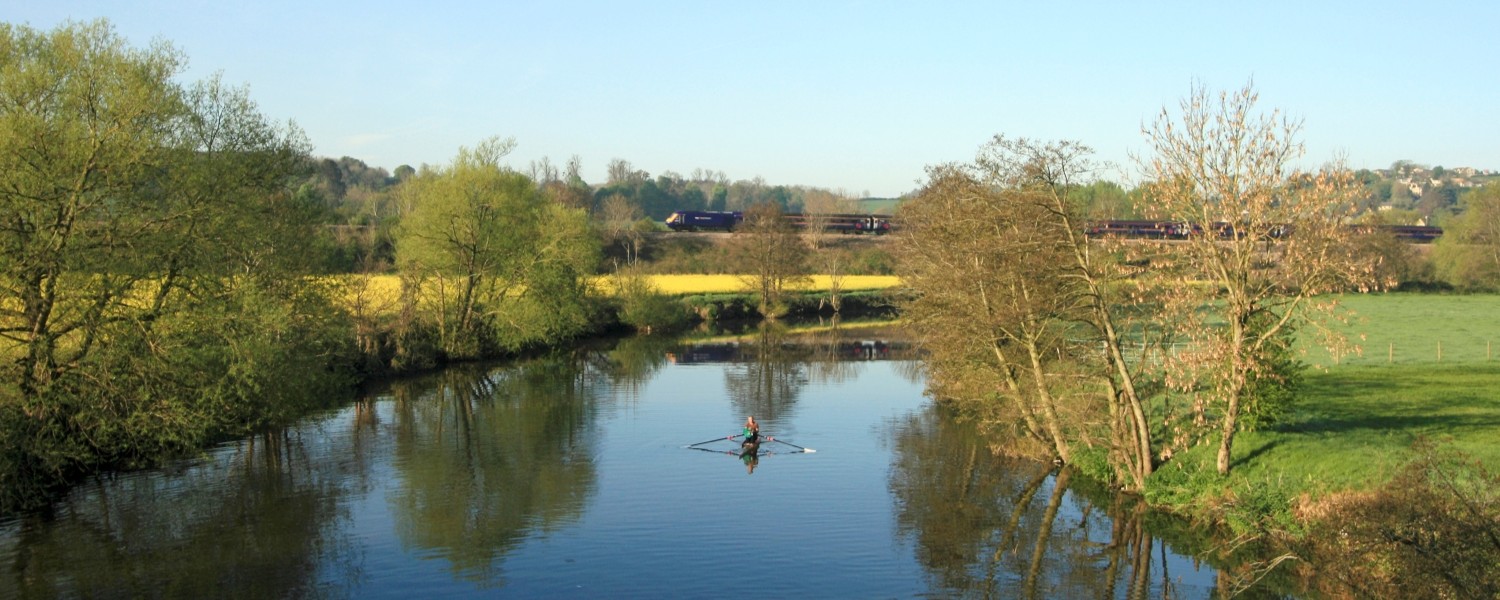 A person rowing on a section of the River Avon