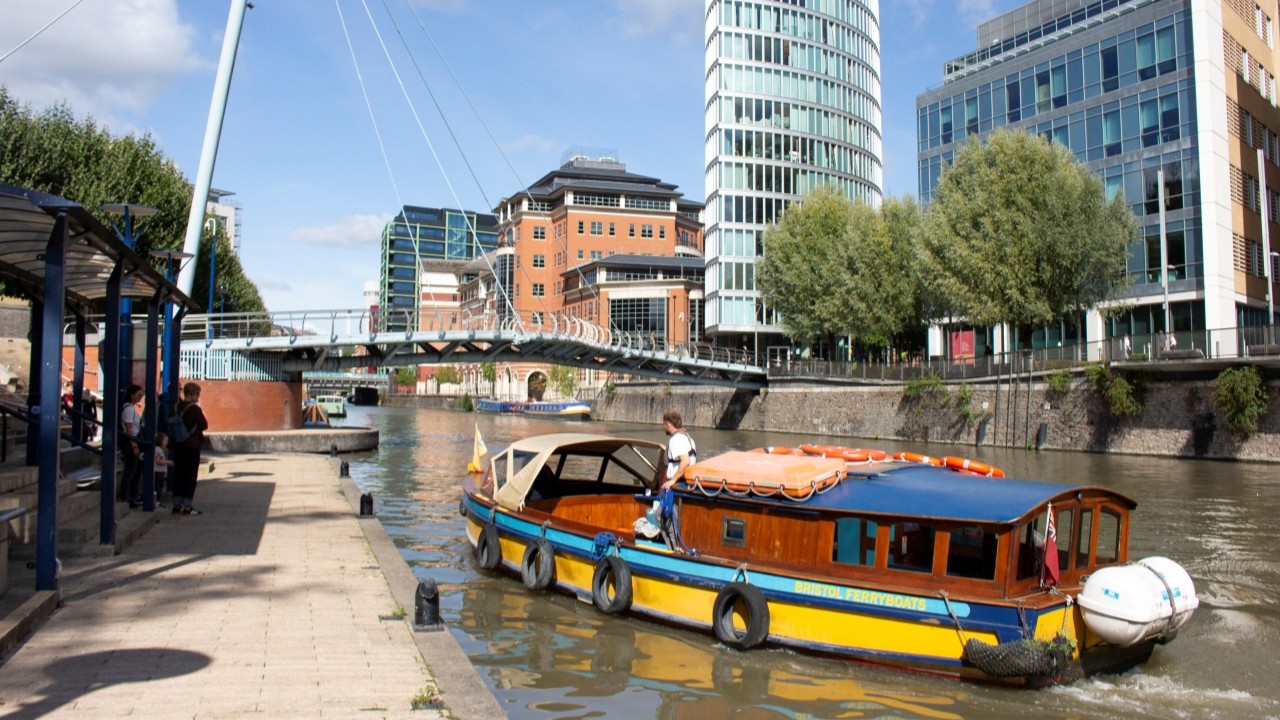 The Bristol Harbour Ferry arriving to pick people up at the ferry stop