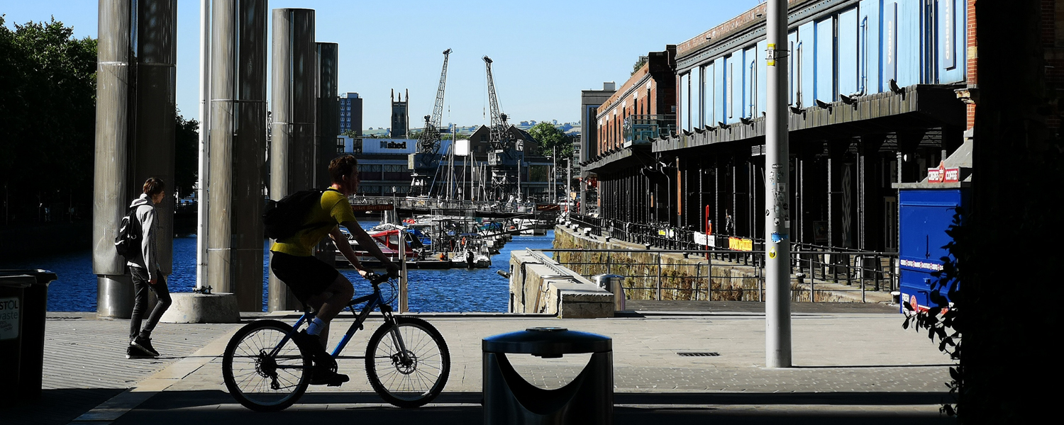 Floating harbour on a sunny day with the Watrshed on the right hand side and the M Shed cranes in the background